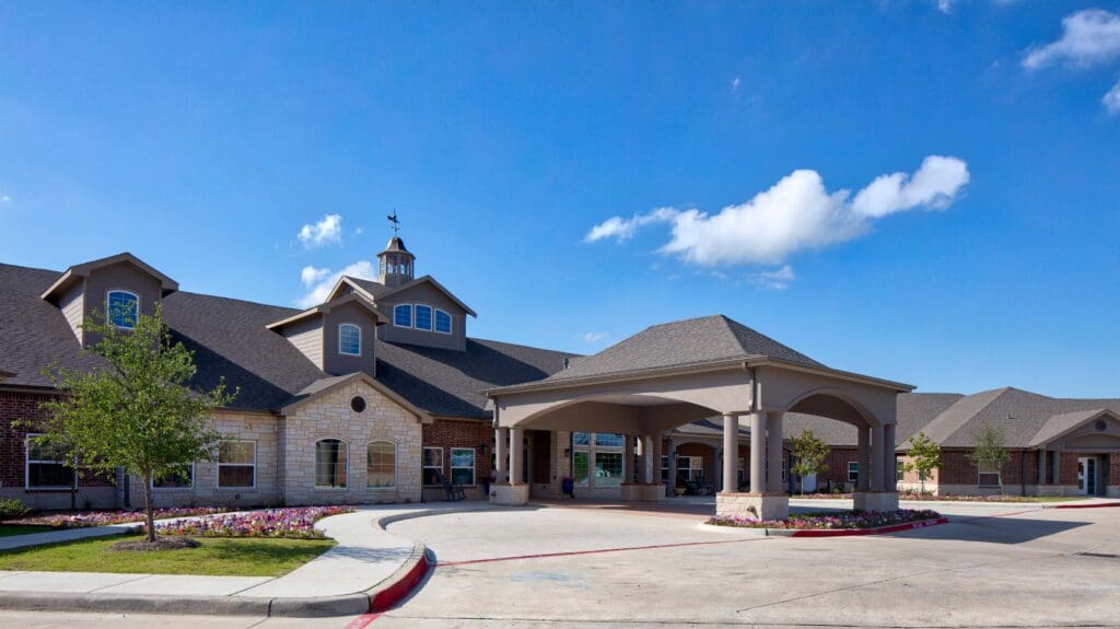 Twin Rivers senior living community main building front entrance during the day.